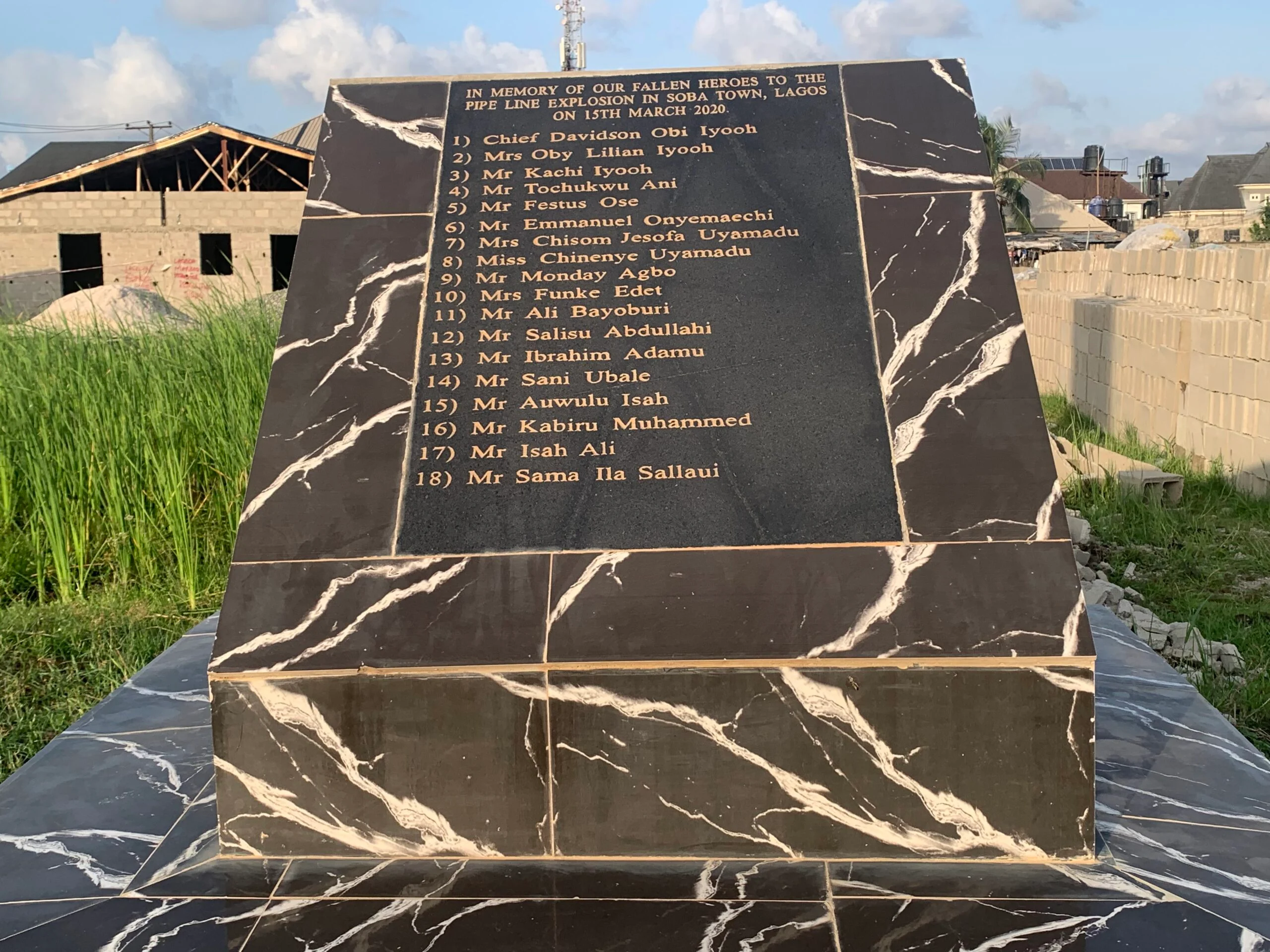 The memorial stone bearing the names of 18 deceased victims